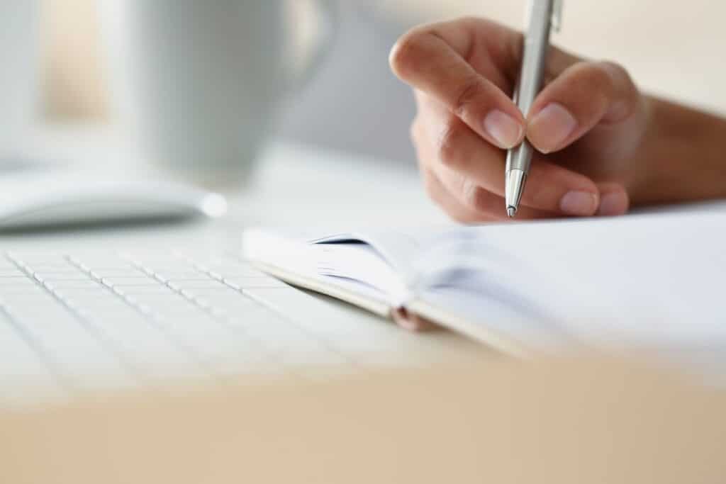 person writing a bid